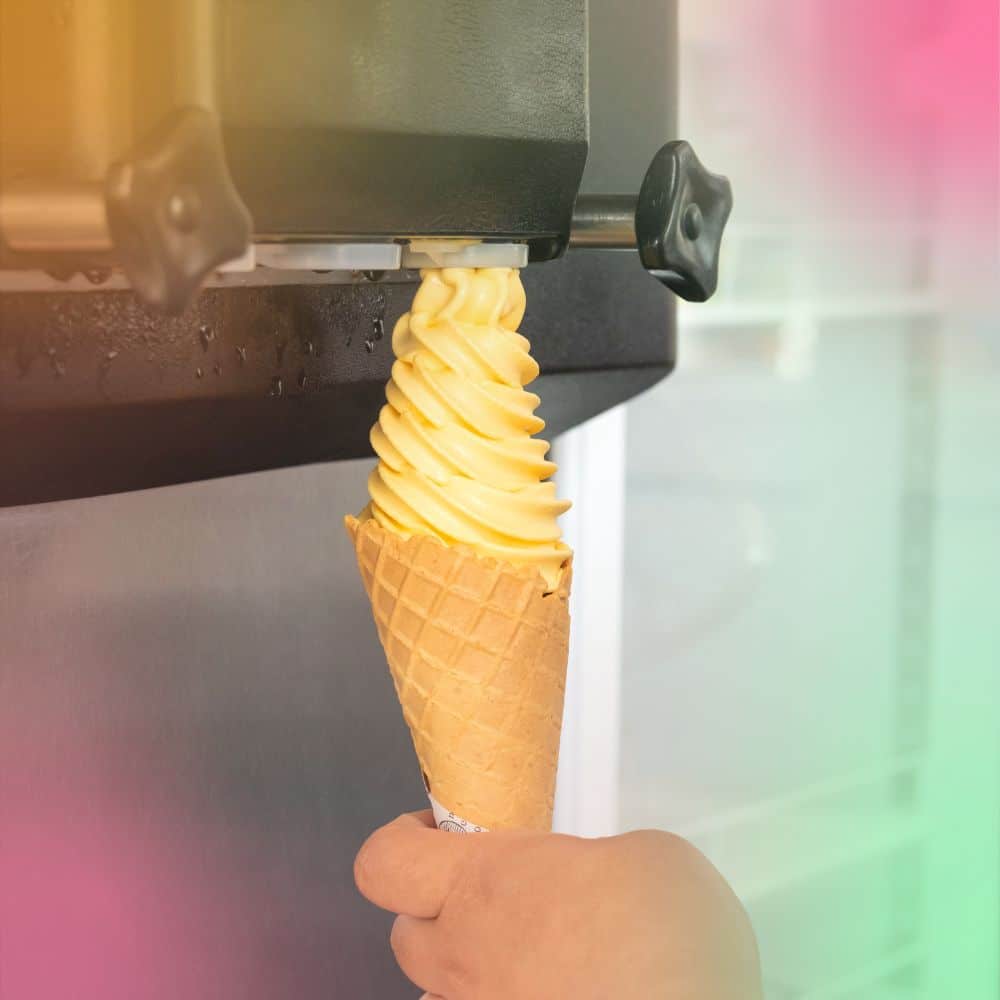 mango frozen yogurt soft serve coming out of machine